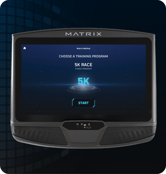 Image of a Matrix workout console. Screen has the Matrix Method starting screen indicating "Choose a Training Program'. Screen is currently selected on the 5K screen as is indicated by the glowing blue Characters above a sci-fi circles beneath. Start button is the last element on the page.