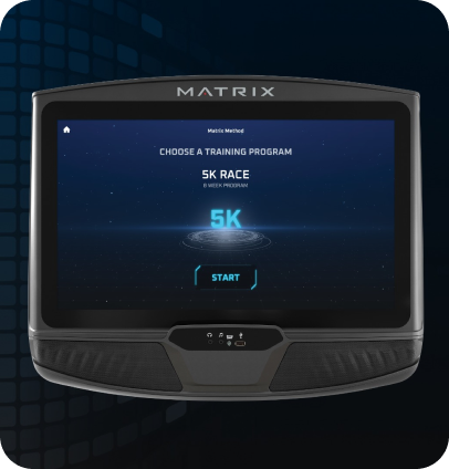 Image of a Matrix workout console. Screen has the Matrix Method starting screen indicating "Choose a Training Program'. Screen is currently selected on the 5K screen as is indicated by the glowing blue Characters above a sci-fi circles beneath. Start button is the last element on the page.