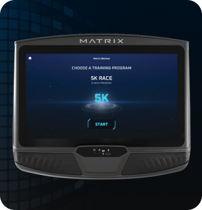 Image of a Matrix workout console. Screen has the Matrix Method starting screen indicating "Choose a Training Program'. Screen is currently selected on the 5K screen as is indicated by the glowing blue Characters above a sci-fi circles beneath. Start button is the last element on the page.