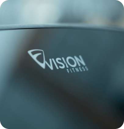 Zoomed in image of the Vision Fitness logo on a console screen at an angle