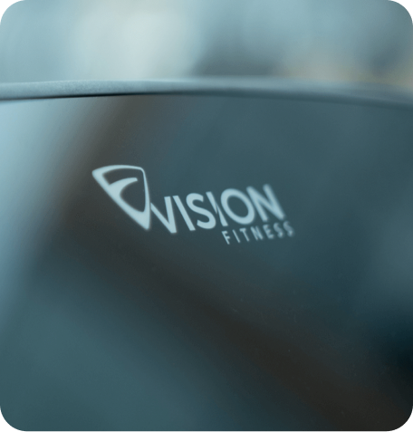 Zoomed in image of the Vision Fitness logo on a console screen at an angle