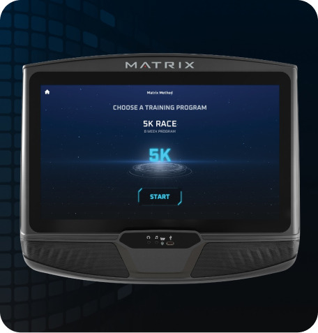 Image of a Matrix workout console. Screen has the Matrix Method starting screen indicating "Choose a Training Program'. Screen is currently selected on the 5K screen as is indicated by the glowing blue Characters above a sci-fi circles beneath. Start button is the last element on the page.