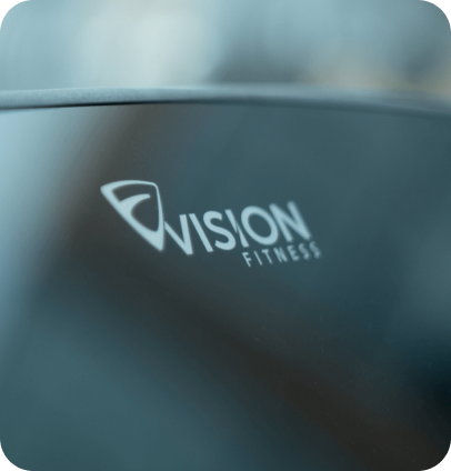 Zoomed in image of the Vision Fitness logo on a console screen at an angle